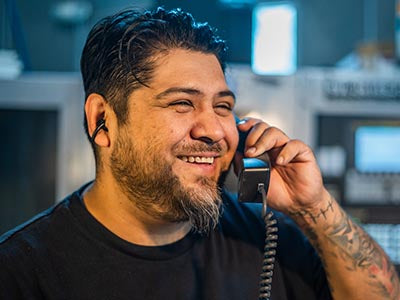 Smiling Gearheart Industry team member talking with a customer on the phone
