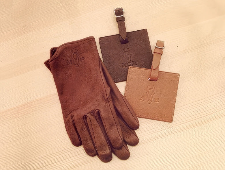 Leather gloves and luggage tags stamped with a custom horse-and-monogram design